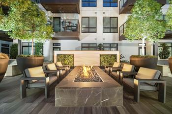 Expansive social courtyards with fire pits, grills, and open-air dining